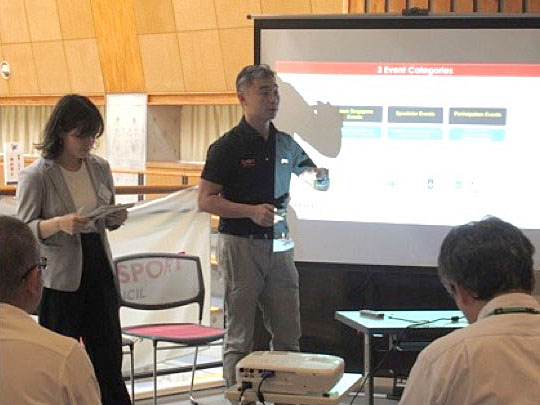 Photo showing Toh Boon Yi (Chief, Singapore Sport Institute) giving a lecture in front of the screen